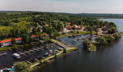 Aerial view of Golden Beach Resort in The Kawarthas from the lake facing the resort showing a marina with boats.